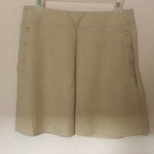 Lil’ beige mini skirt with buttons up both sides